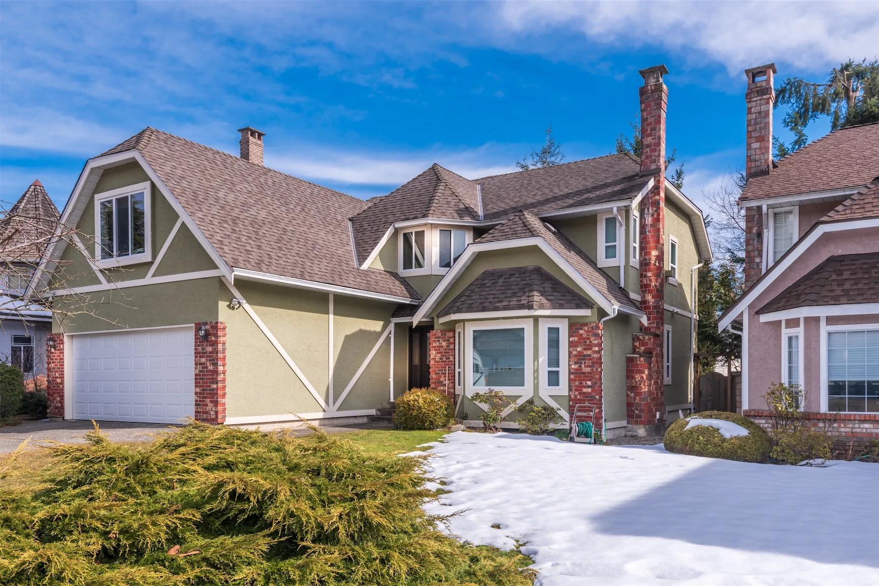 Two-story home with landscaped front yard in spring