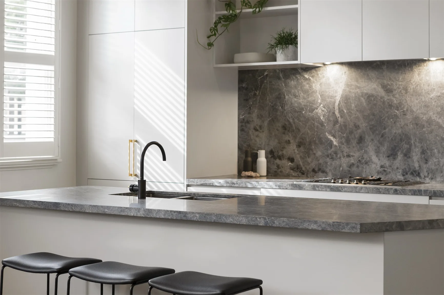 Sleek kitchen interior with marble backsplash